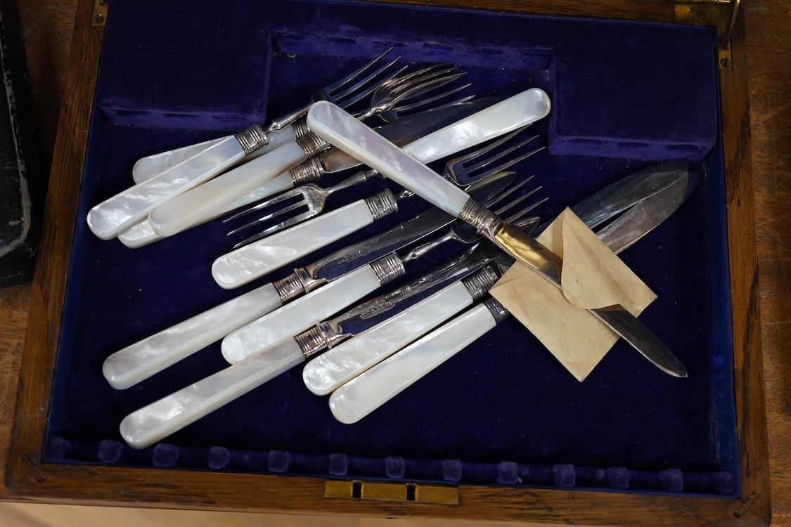 A quantity of assorted plated items including entrée dishes, flatware and mugs.
